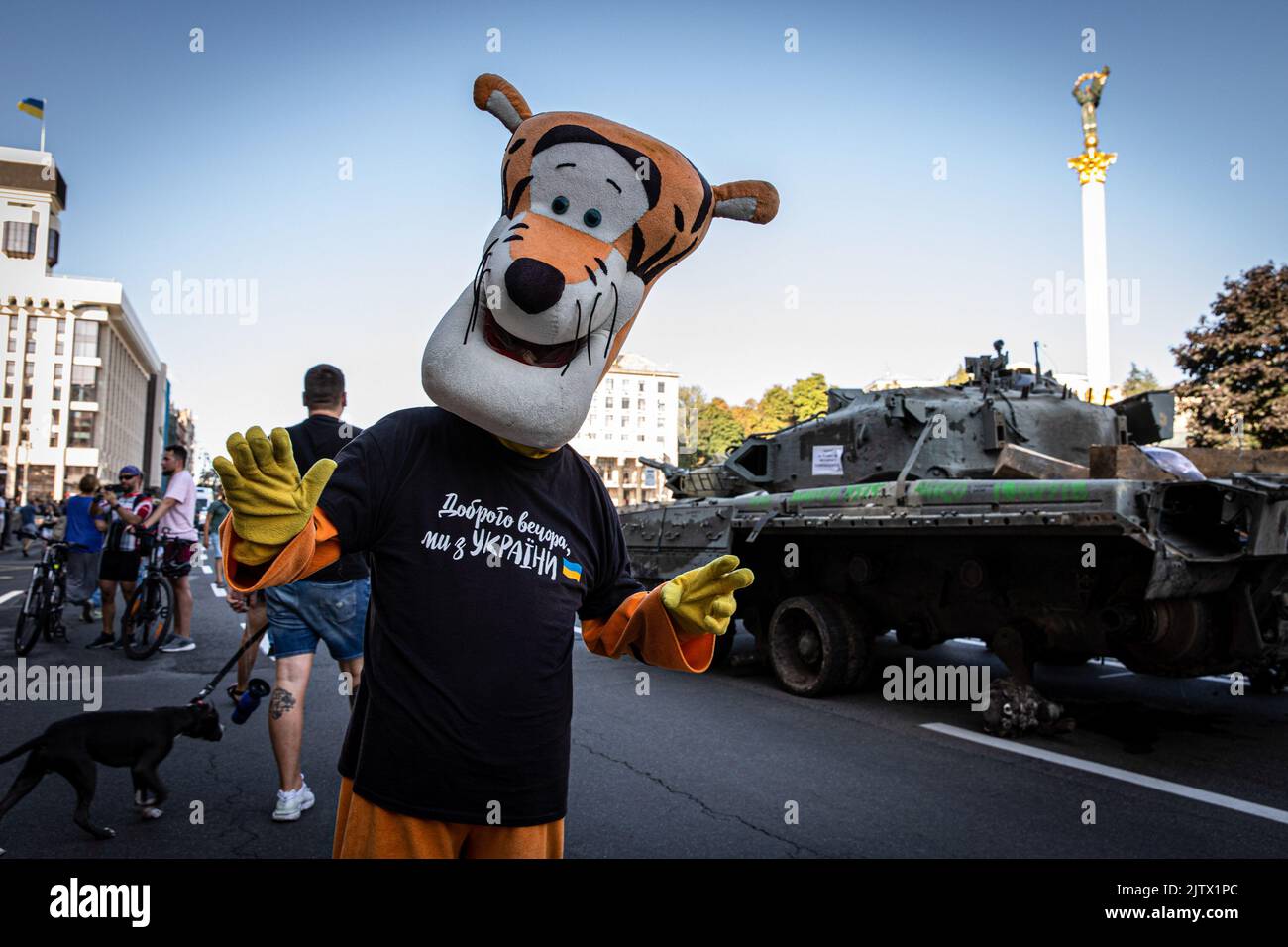 Kyiv, Ukraine. 24th Aug, 2022. A man dressed up like the cartoon character 'Tigger' seen on the streets in Kyiv, Ukraine, as people flock to see the demolished Russian tanks on the streets. Amid the Independence Day of Ukraine, and nearly 6 months after the full-scale invasion of Ukraine on February 24, the country's capital Kyiv holds an exhibition on the main street of Khreschaytk Street showing multiple destroyed military equipment, tanks and weapons from The Armed Forces of The Russian Federation (AFRF). Credit: SOPA Images Limited/Alamy Live News Stock Photo