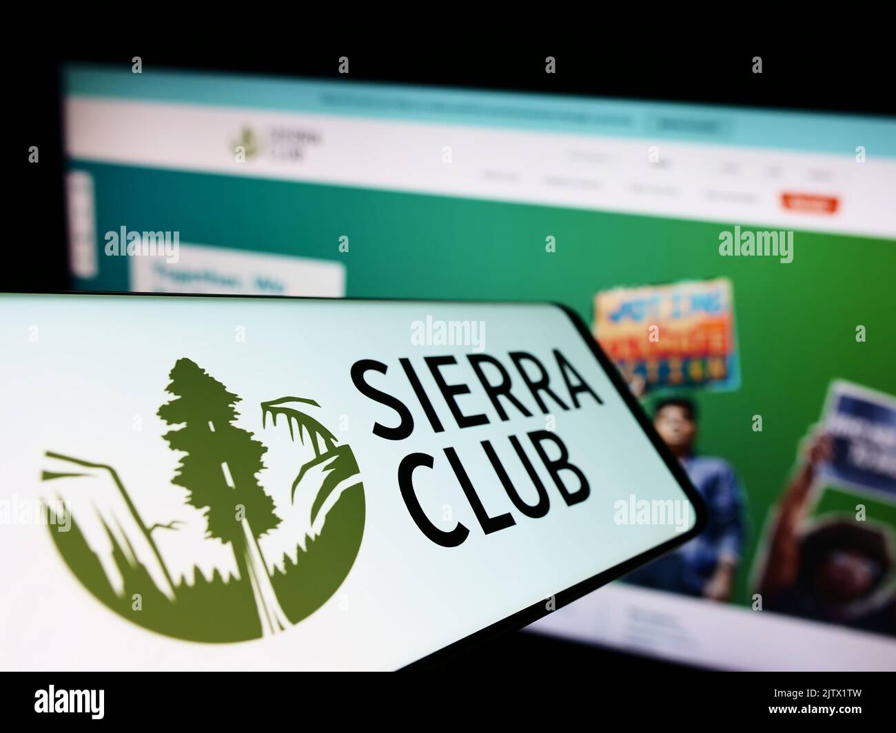 Cellphone with logo of American environmental organization Sierra Club on screen in front of website. Focus on center of phone display. Stock Photo
