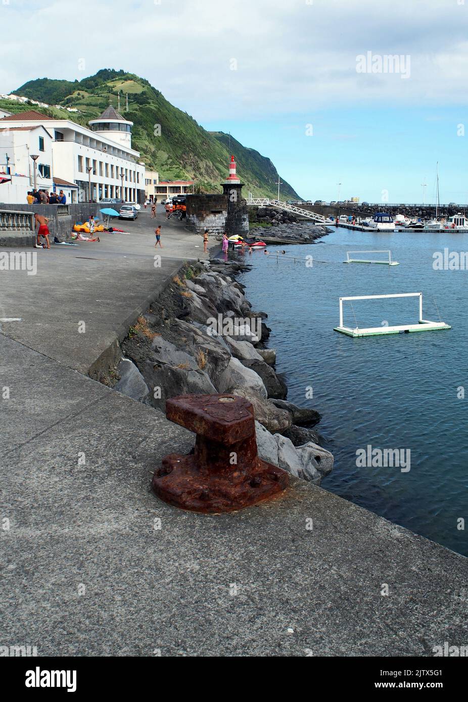 The town's stoneclad waterfront and marina, Povoacao, Sao Miguel Island, Azores, Portugal Stock Photo