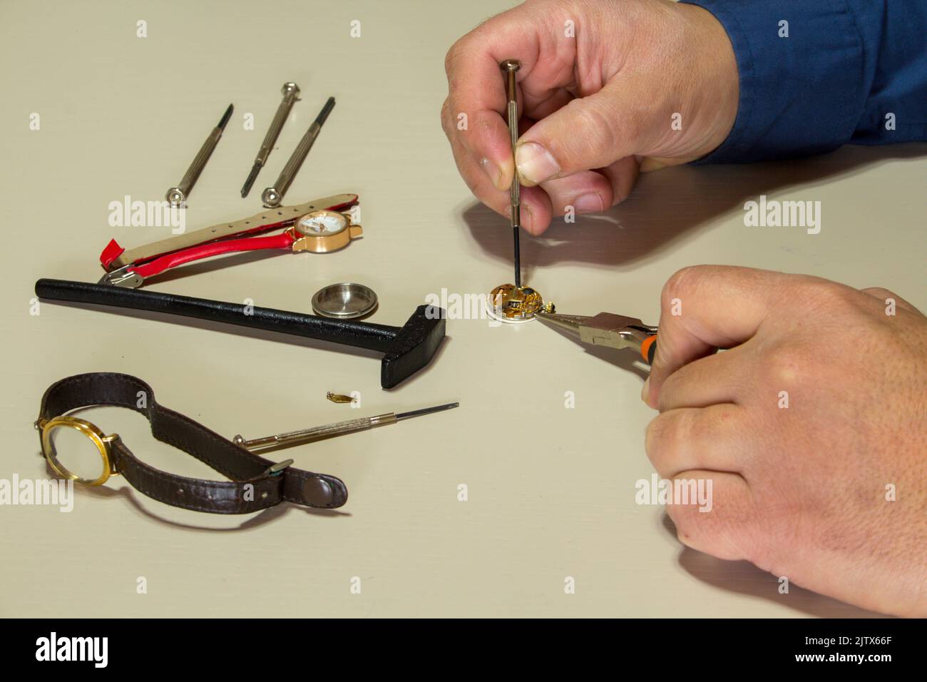 hands of a man while repairing watches. Watchmaker at work Stock Photo