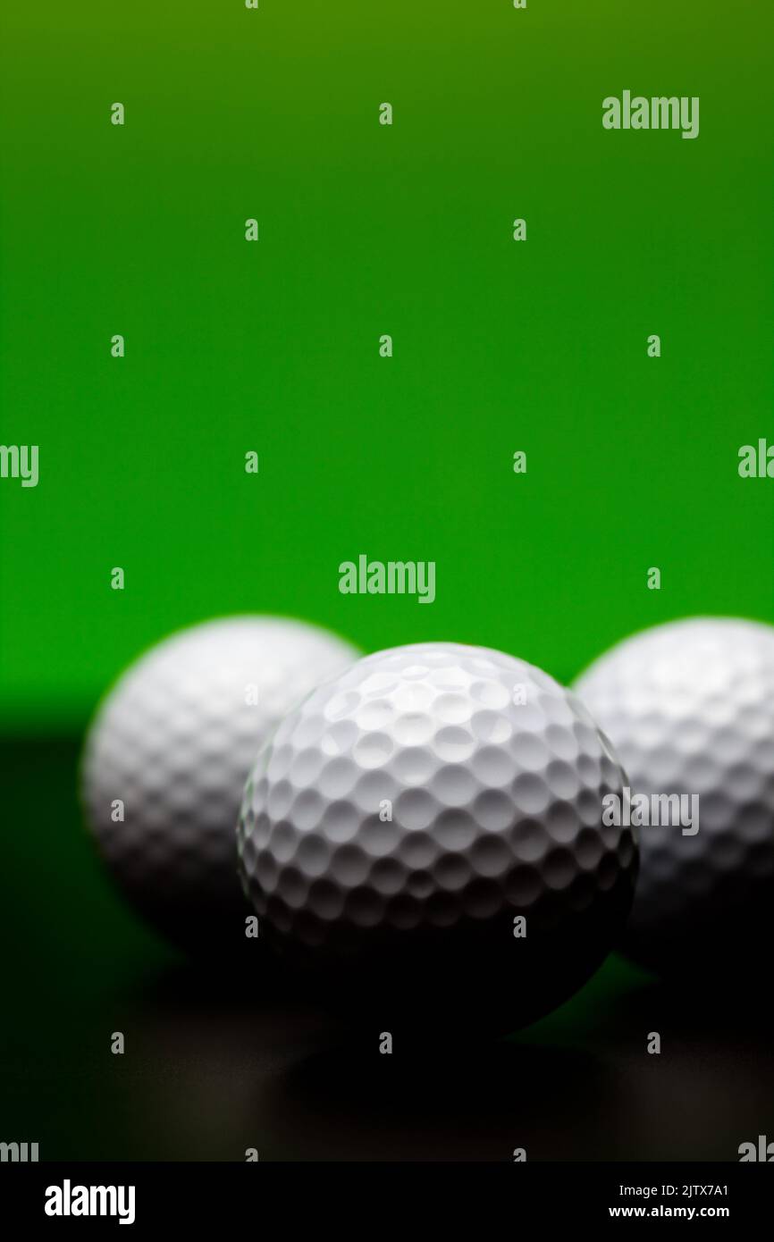 three golf balls against green Stock Photo Alamy