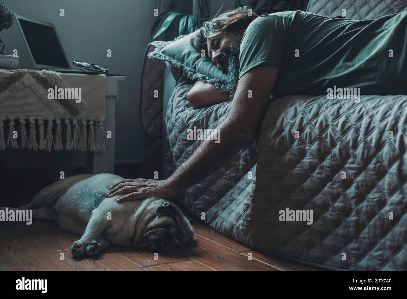 Love and friendship with man and dog. Animal owners living in friendship with pug. Male sleep with his dog. Domestic canine lifestyle concept owner Stock Photo