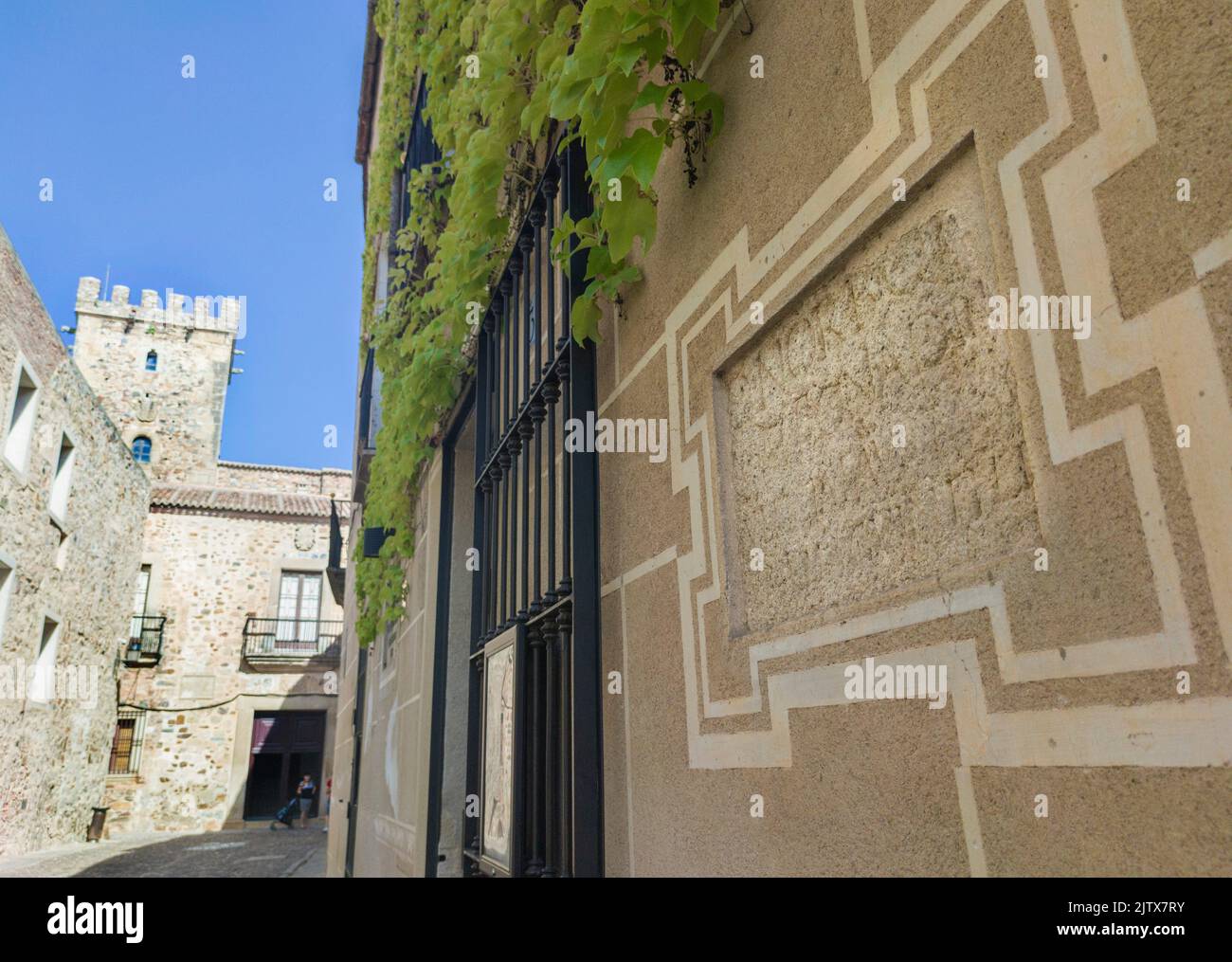 Roman tombstone built in historic quarter house. Roman remains still visible at Sande Palace, Caceres, Extremadura, Spain. Stock Photo