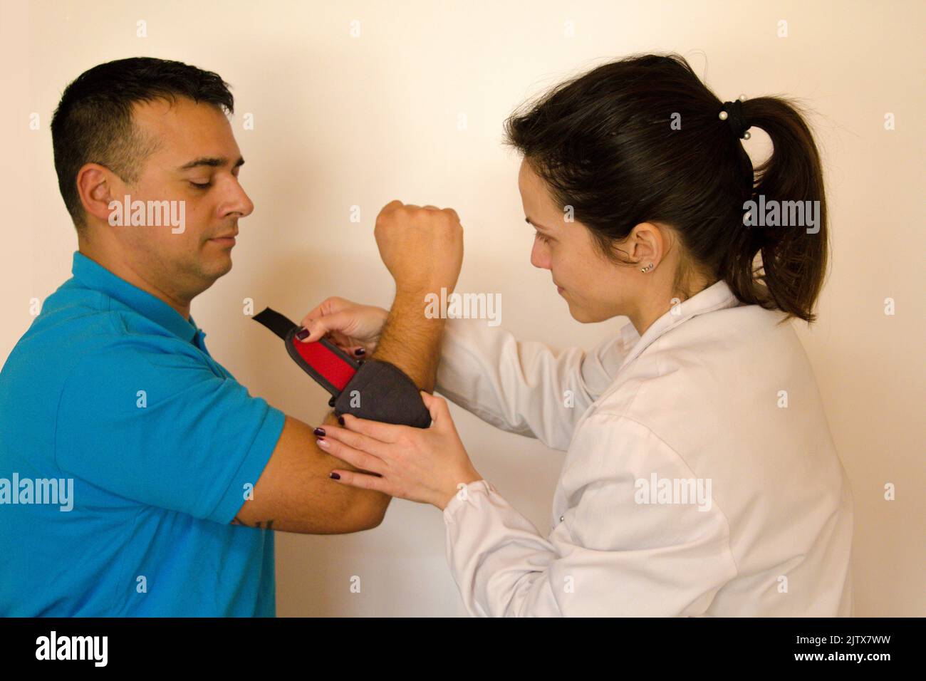 Image of a female physiotherapist showing a patient suffering from
