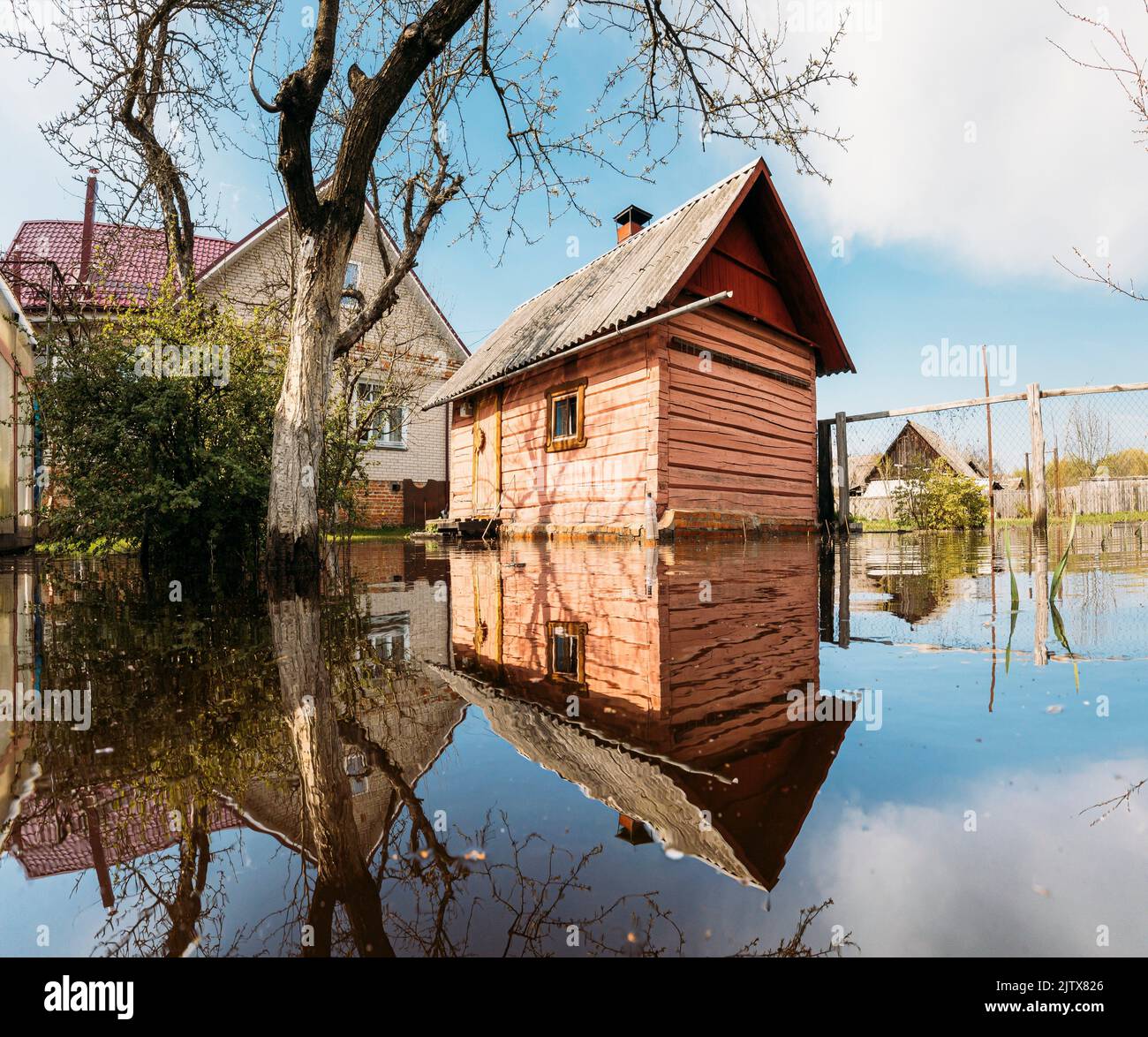 Old wooden Sauna bath building In Water During Spring Flood floodwaters during natural disaster. Water deluge During A Spring Flood. inundation River. Stock Photo