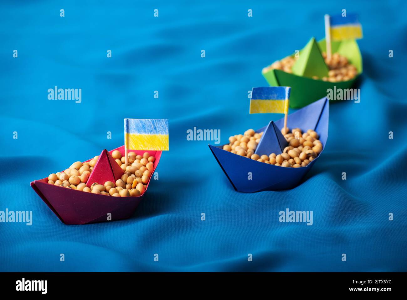 Boats with Ukrainian soybeans made of paper origami concept Stock Photo