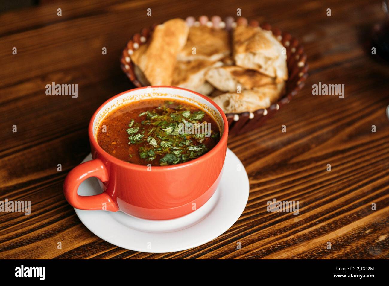 Georgian cuisine. Kharcho or Harcho is a traditional Georgian soup containing beef, rice, cherry plum puree and chopped walnuts - Juglans regia. The Stock Photo