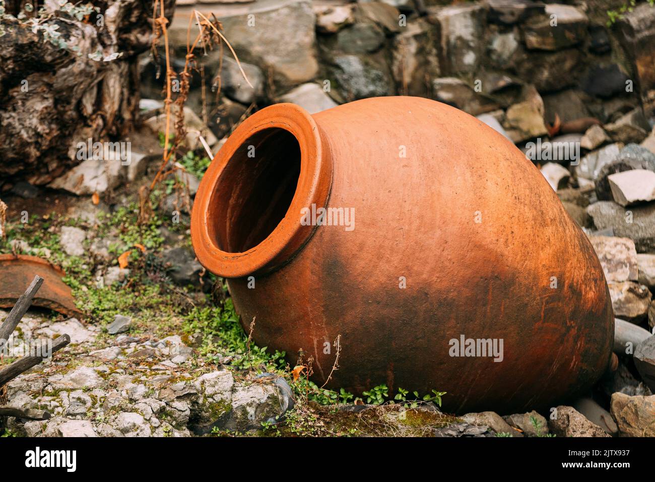 old Abandoned Kvevri on Ground. The Large Earthenware Vessel Used For The Fermentation, Storage And Ageing Of Traditional Georgian Wine. Stock Photo