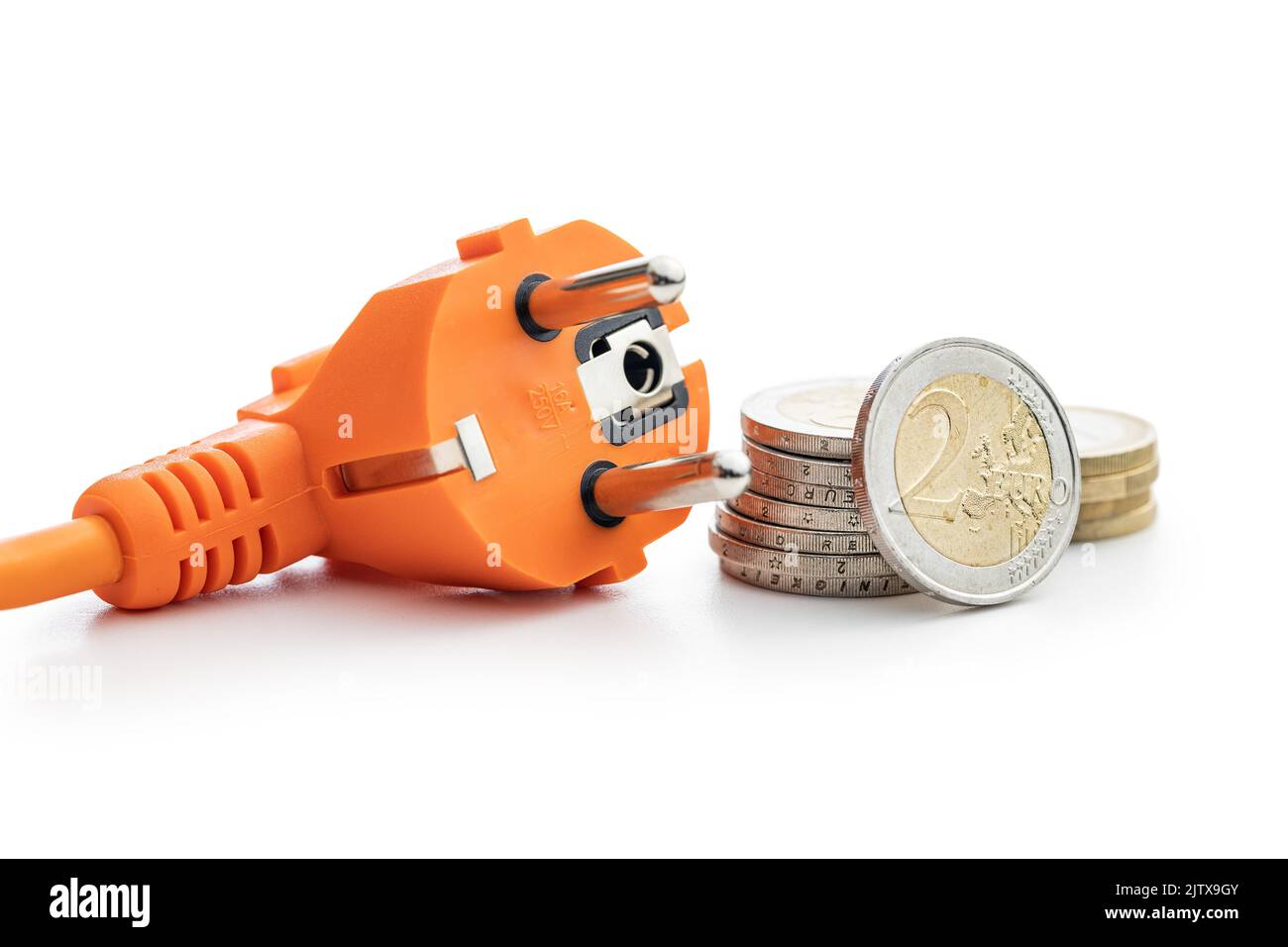 Electric plug and euro coins isolated on the white background. Concept of increasing electricity prices. Stock Photo