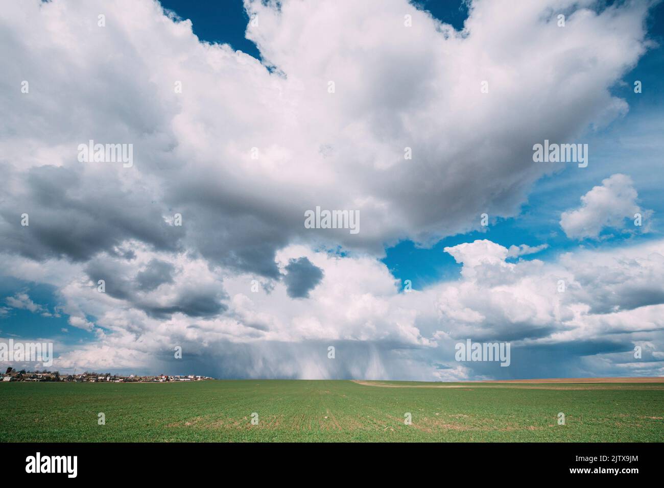 Sky During Rain Horizon Above Rural Landscape Field. Agricultural And Weather Forecast Concept. Storm, Thunder, thunderstorm, stormclouds, Rainy Day, Stock Photo