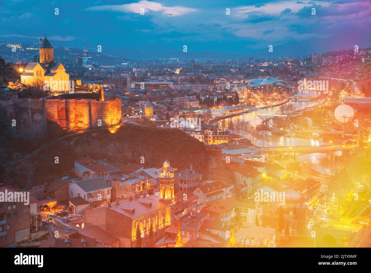 Tbilisi, Georgia. Elevated Top View Of Famous Landmarks In Night Illuminations. Georgian Capital Skyline Cityscape. City in Night Illuminations. Stock Photo