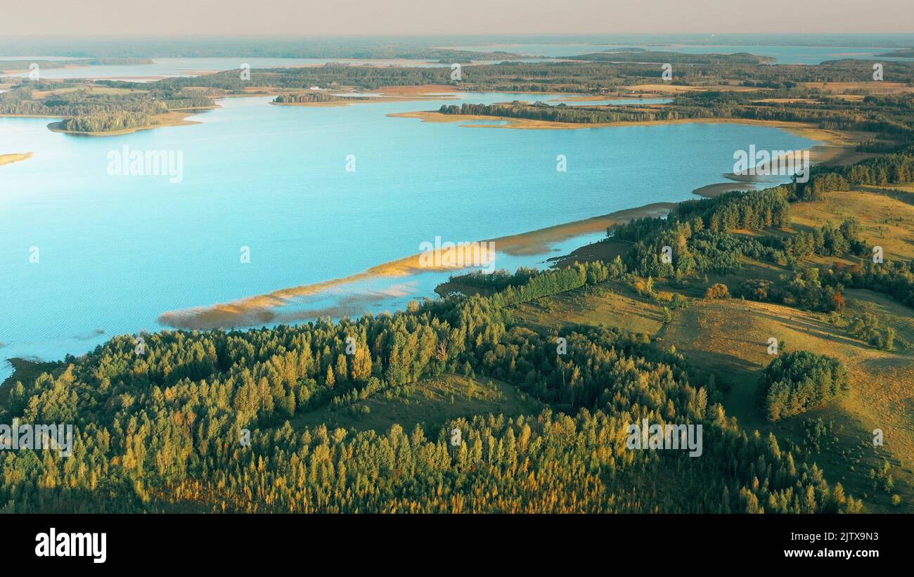 4K Aerial View Of Lake And Green Forest Landscape In Sunny Summer Morning. Top View Of Beautiful European Nature From High Attitude. Bird's Eye View. Stock Photo