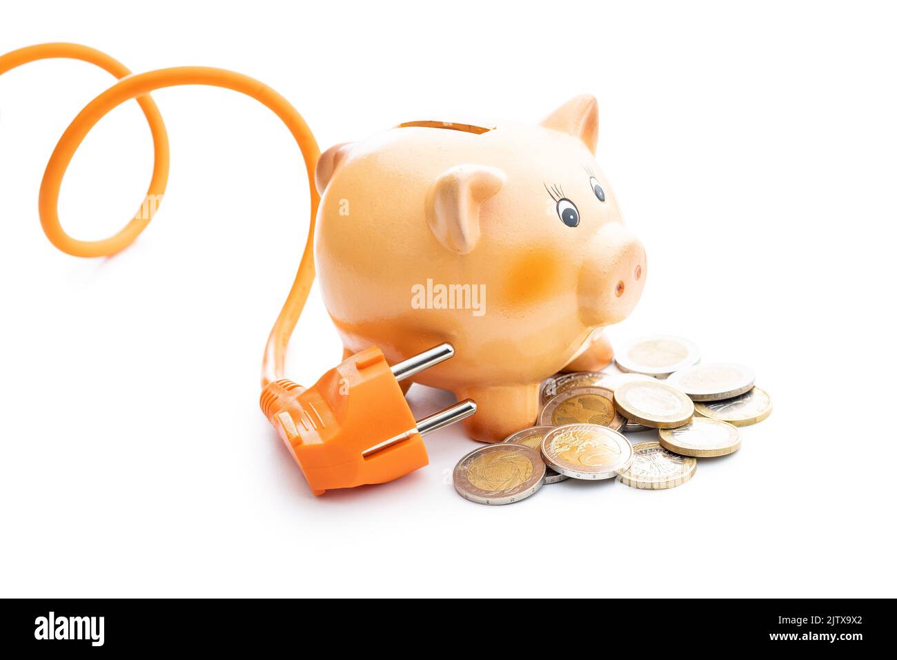 Orange electric plug,coins and piggy bank isolated on the white background. Concept of increasing electricity prices. Stock Photo