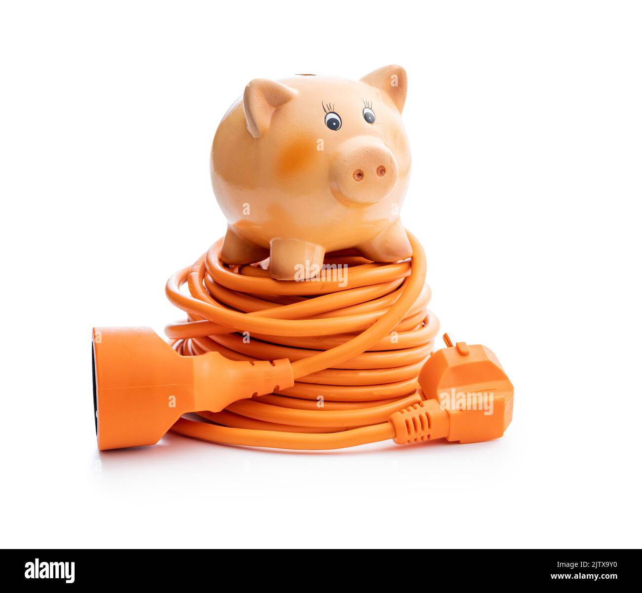 Orange extension power cord and piggy bank isolated on the white background. Stock Photo