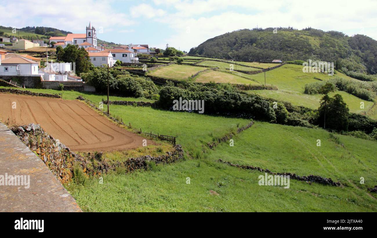 Rural landscape, with a town, rolling toward Atlantic Ocean, on the North side of the island, Terceira Island, Azores, Portugal Stock Photo