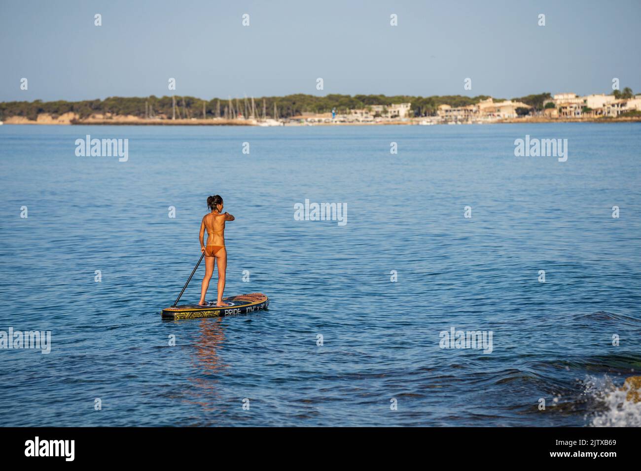 lonely woman practicing paddle surfing in the Mediterranean, Sa Rapita, Campos, Mallorca, Balearic Islands, Spain. Stock Photo