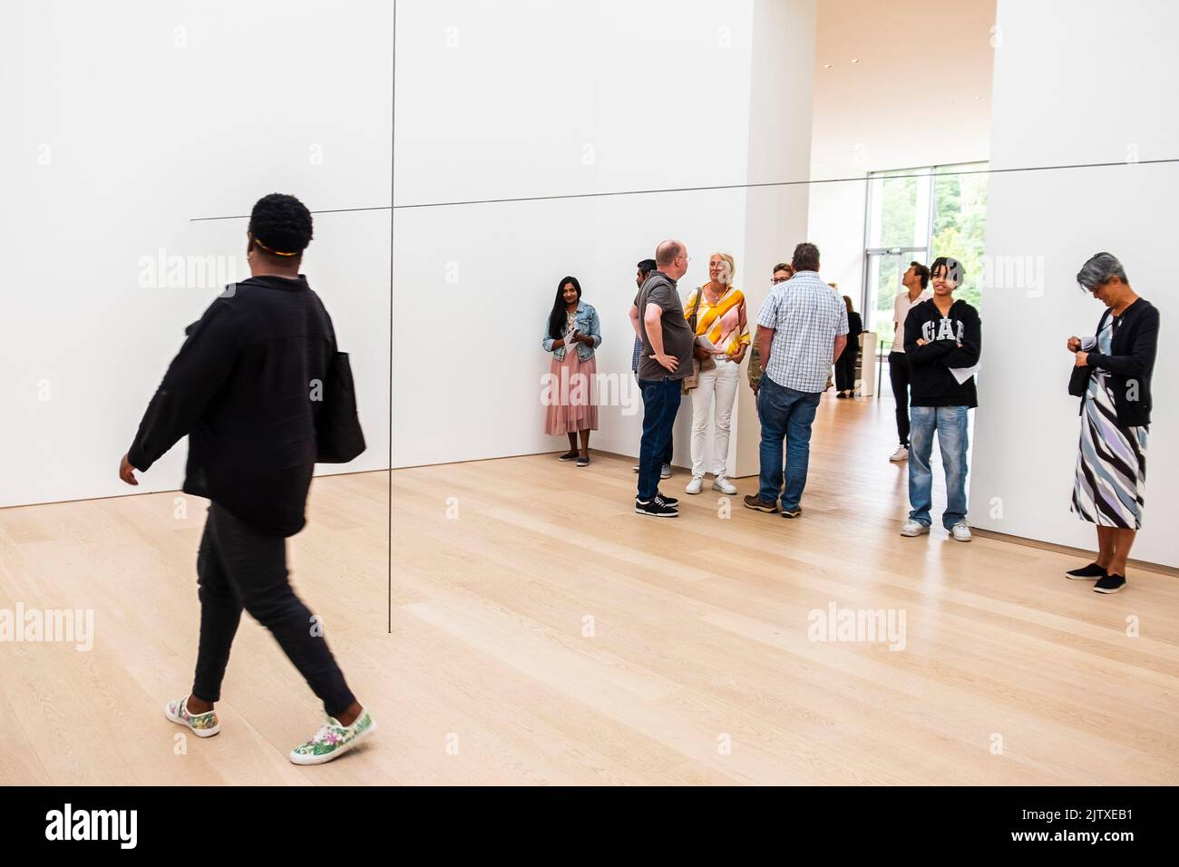 Visitors exploring the art exhibition of Antony Gormley in museum Voorlinden, Netherlands. Stock Photo