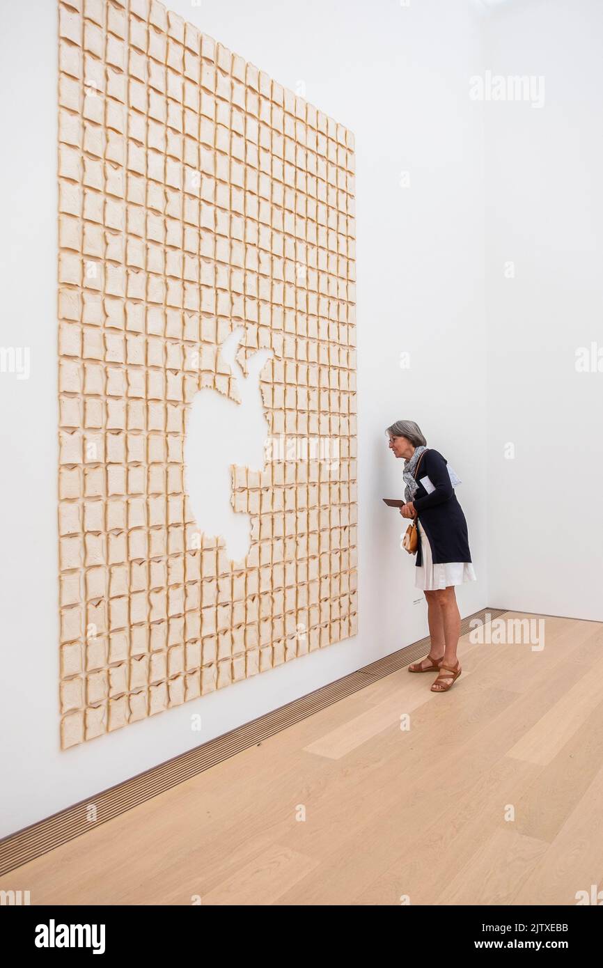 Visitor exploring the art exhibition of Antony Gormley in museum Voorlinden, Netherlands. Stock Photo