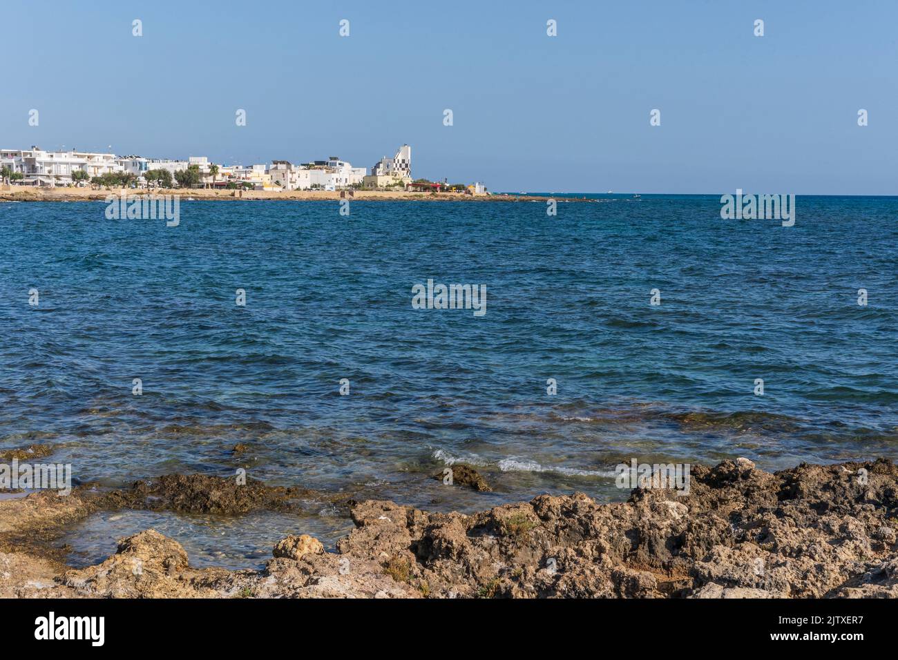 scenic-view-of-torre-san-giovanni-and-its-rocky-shore-with-lighthouse