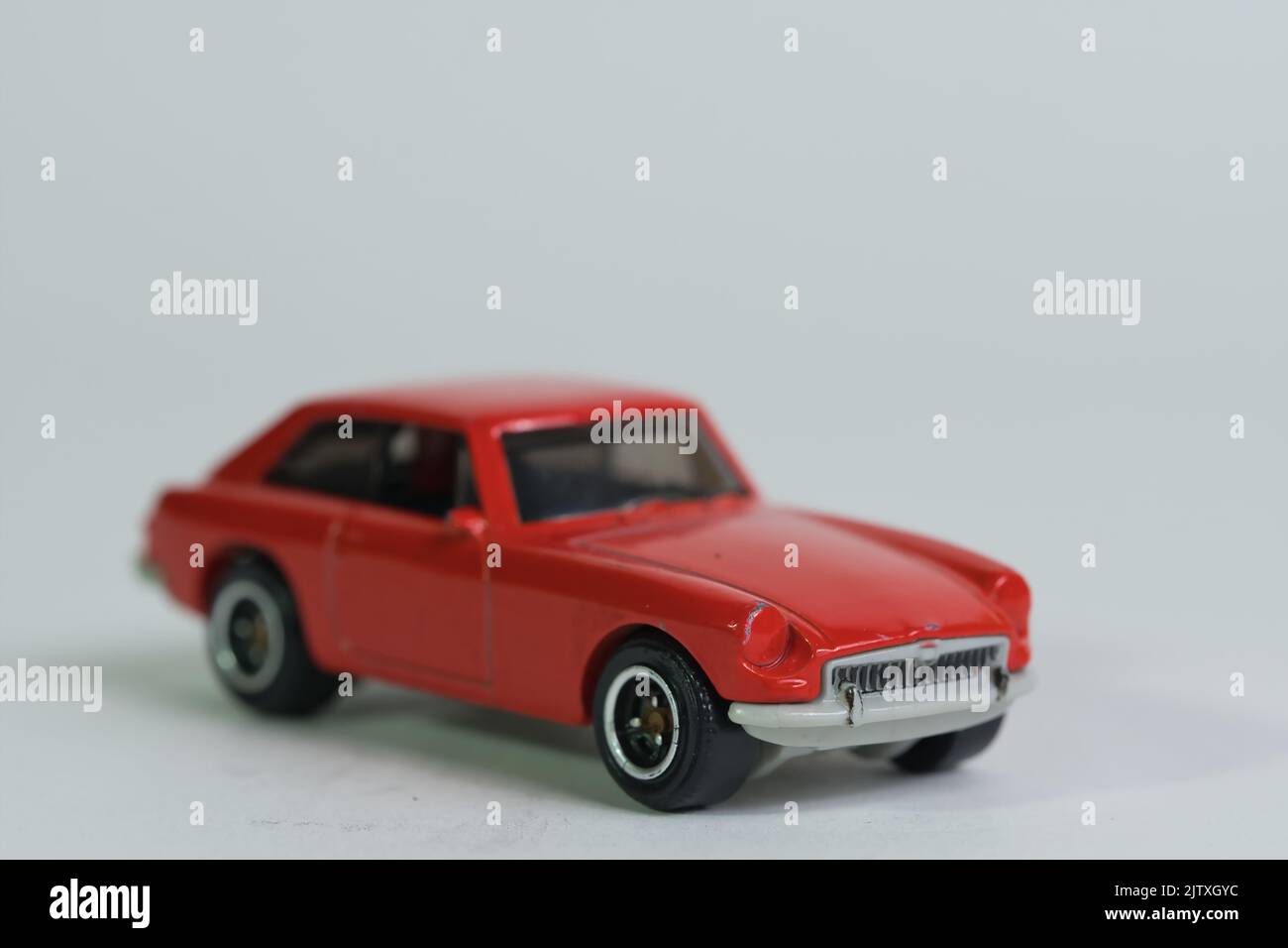 isolated red sport vintage toy car on white background, front view ...
