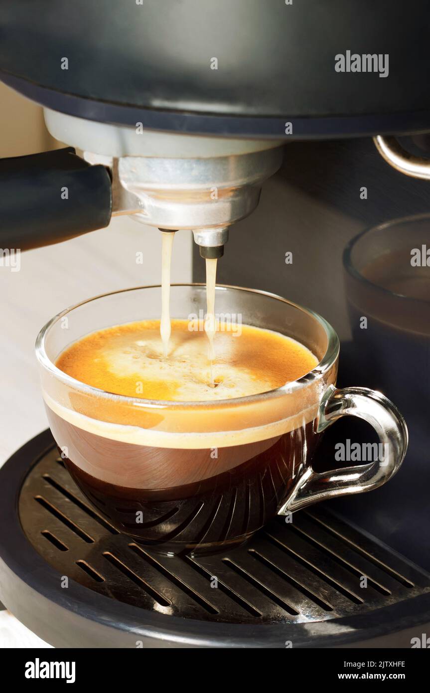 Coffee machine with transparent cup with fresh espresso. Process of