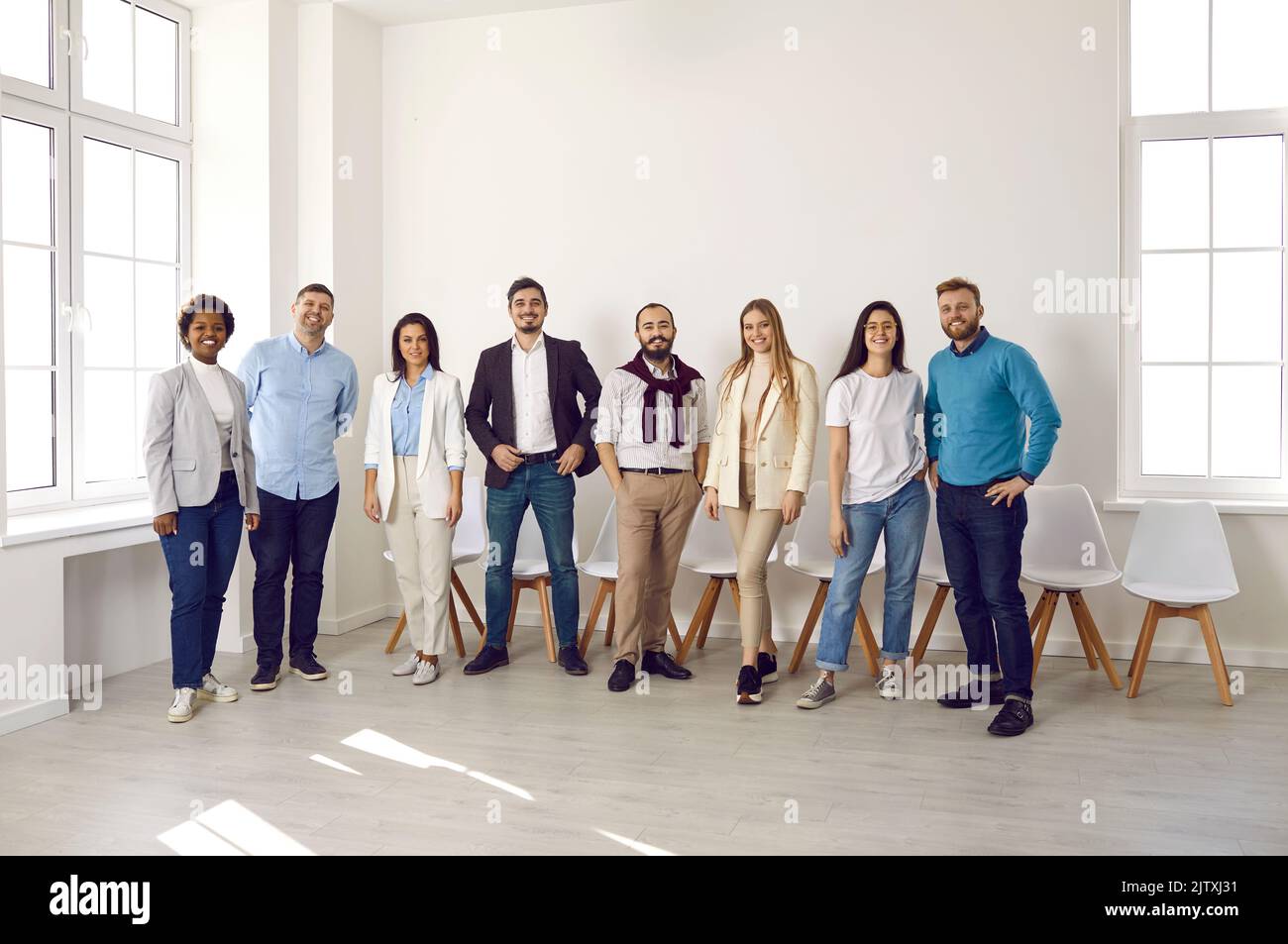 Smiling multiethnic employees pose together in office Stock Photo