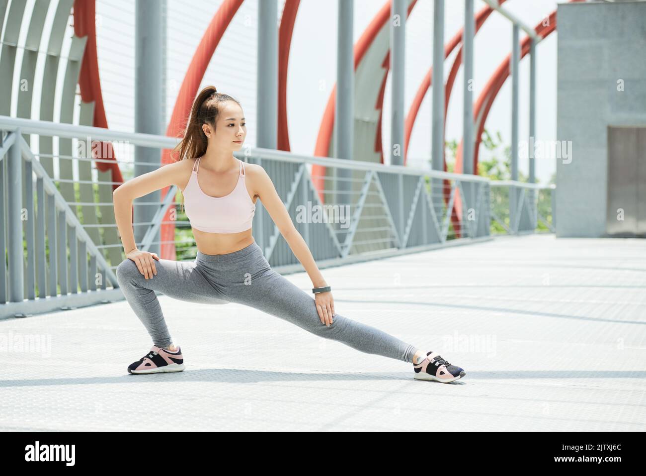 Beautiful young VIetnamese woman stretching legs Stock Photo Alamy