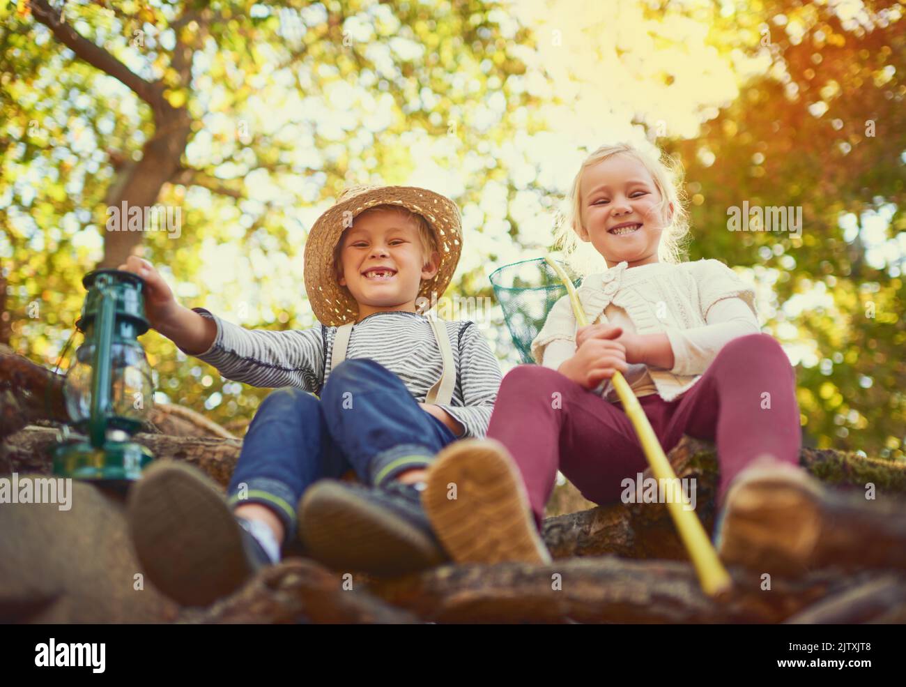 Out for an adventure together. Portrait of two little children playing together outdoors. Stock Photo
