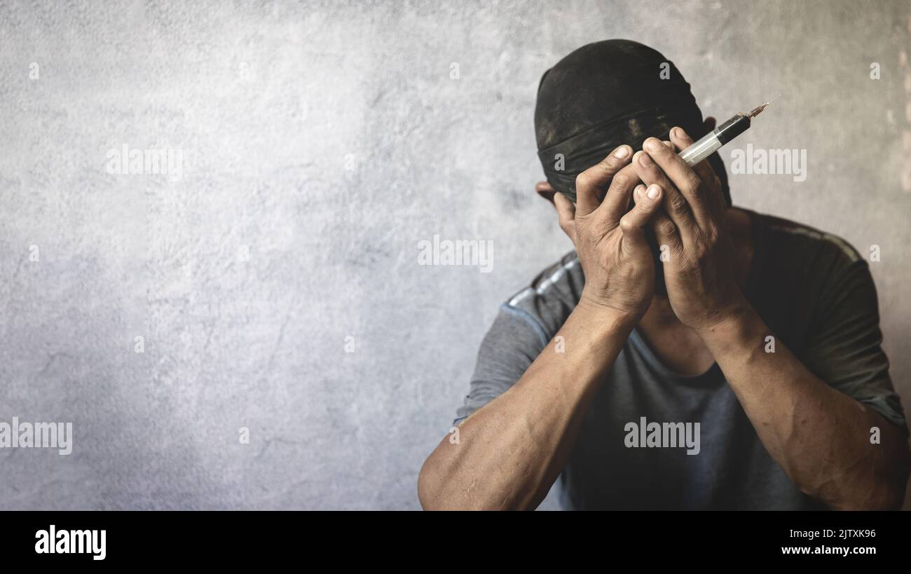 A crazed drug addict reaches for another dose of the drug in the