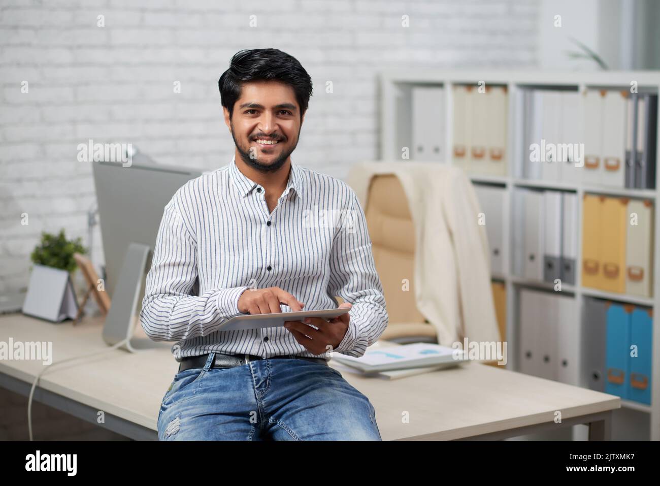 Indian It company manager using application on tablet computer Stock Photo