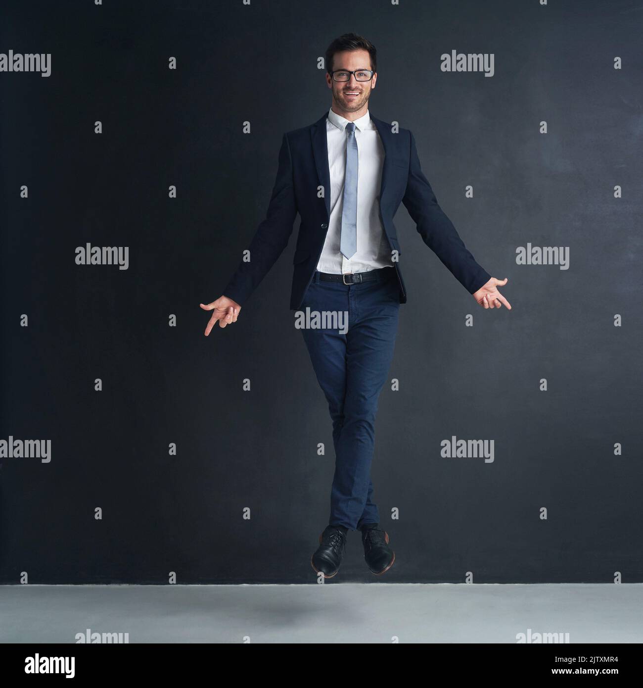 Success has him floating on air. Studio portrait of a businessman in