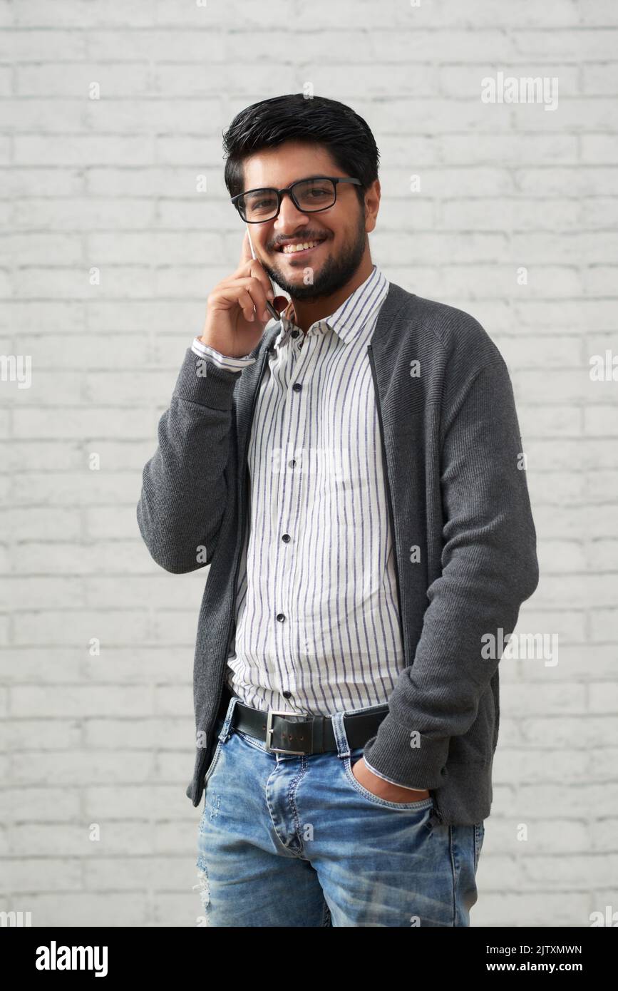 Portrait of cheerful young man calling on phone Stock Photo