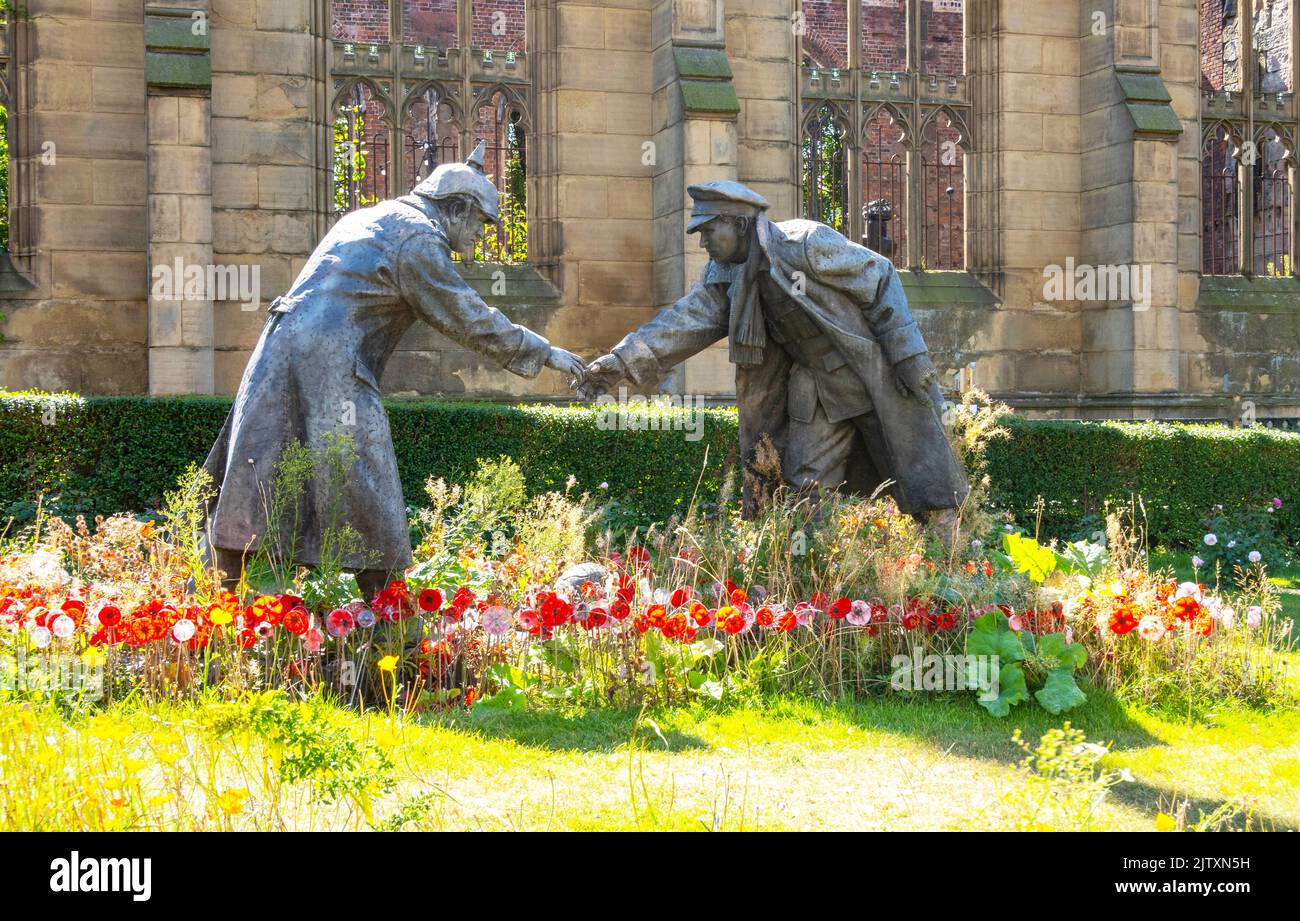 All Together Now, the WW1 Christmas Truce sculpture by Andy Edwards in the garden of St. Luke's, Liverpool's Bombed Out Church Stock Photo