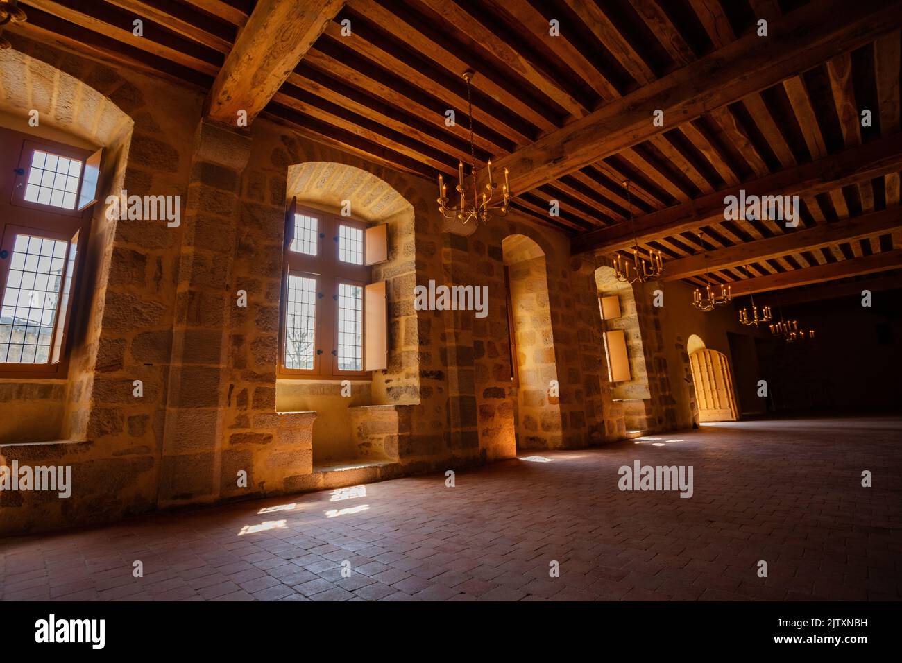 Old castle building interior with stone walls and wooden ceiling Stock Photo