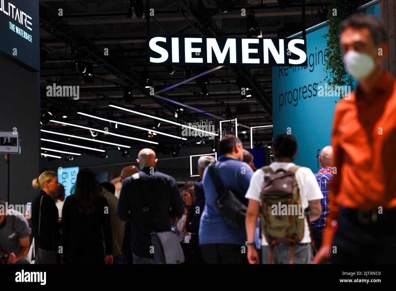 Visitors walk under a Siemens sign at the international consumer technology fair IFA in Berlin, Germany September 2, 2022. REUTERS/Lisi Niesner Stock Photo