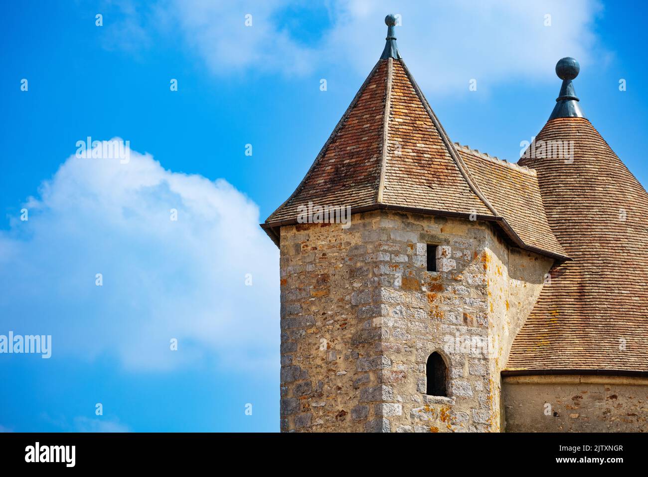 Close-up of medieval castle square towers over blue sky Stock Photo