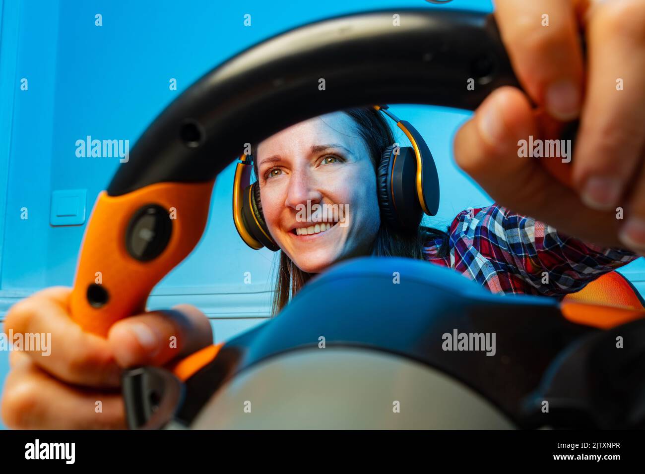 Through the steering wheel view of gamer woman play race game Stock Photo Alamy
