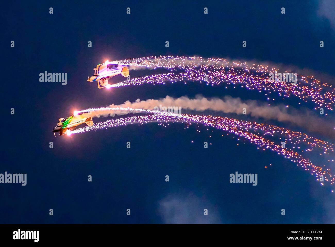 Bournemouth, Dorset, UK. 1st September 2022. The Firebirds lit with neon lights let off fireworks as they do their acrobatic display during night air at dusk on the first day of the Platinum Jubilee Bournemouth Air Festival at Bournemouth in Dorset Picture Credit: Graham Hunt/Alamy Live News Stock Photo