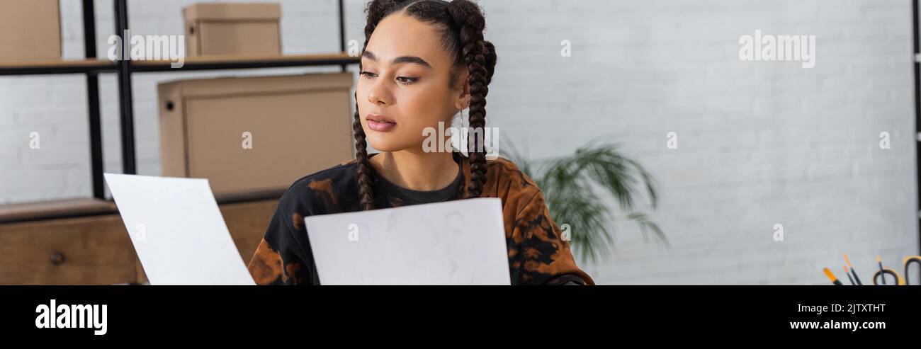 African american designer holding papers in workshop, banner,stock image Stock Photo