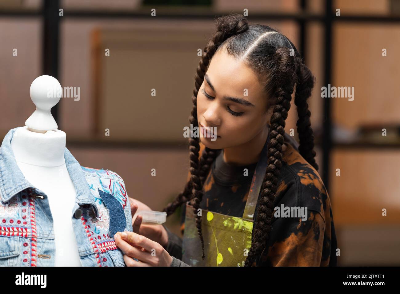 African american craftswoman decorating denim jacket on mannequin,stock image Stock Photo