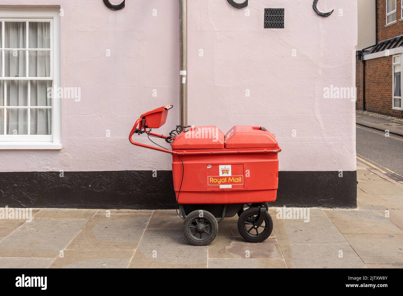 Newcastle-under-Lyme, Staffordshire-united kingdom April, 14, 2022  A bright red Royal Mail delivery trolley on a residential street Stock Photo