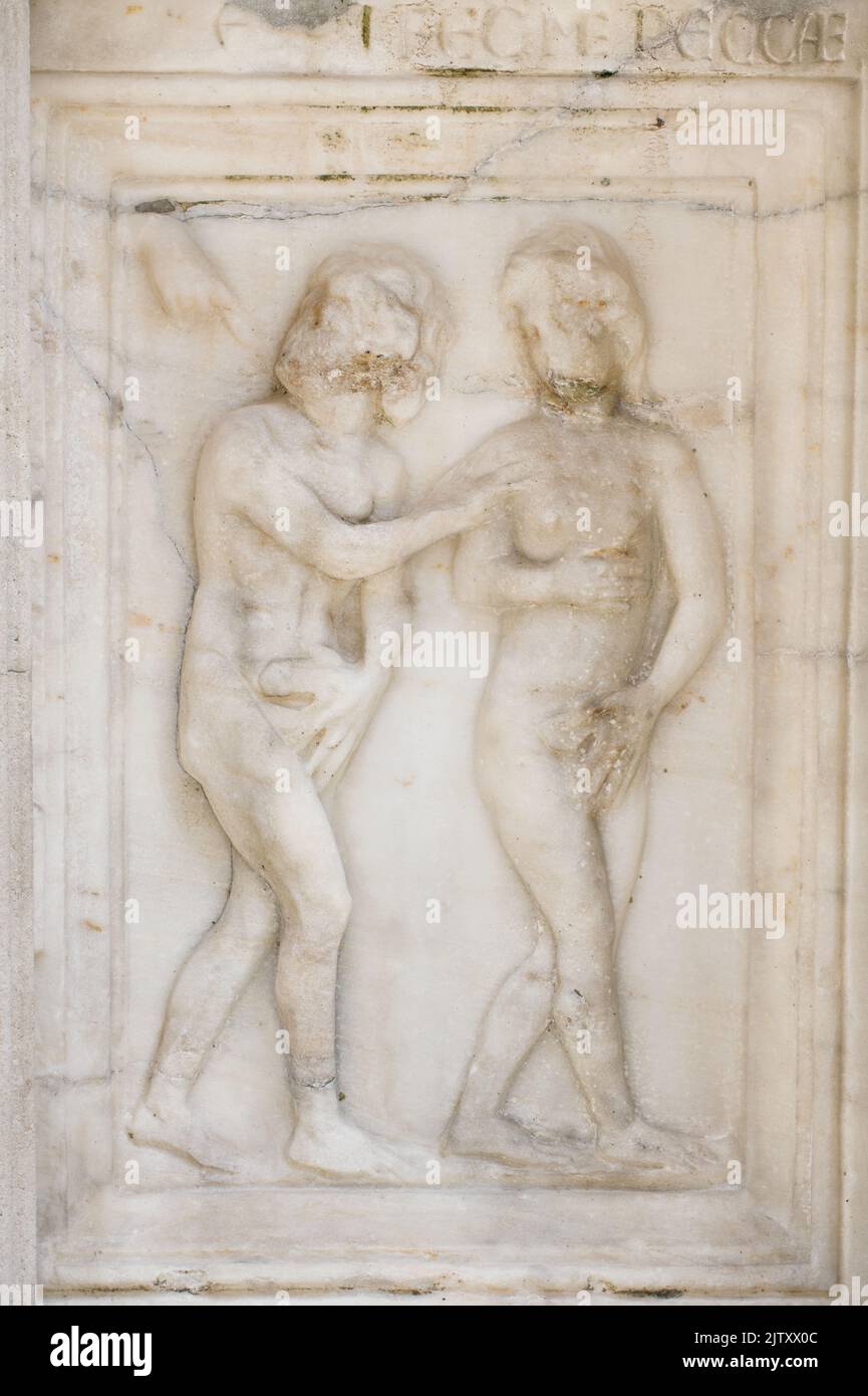 Adam and Eve: the expulsion from Eden - detail of Fontana Maggiore (1275), a masterpiece of medieval sculpture symbol of the city of Perugia - Italy Stock Photo