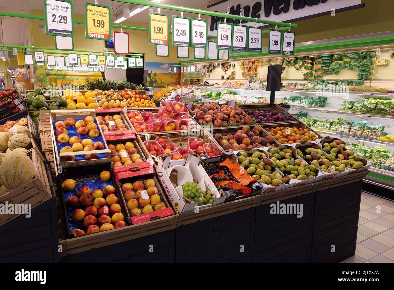 Fossano, Italy - August 30, 2022: stalls with fruit and vegetables in italian supermarket Eurospin, summer fruit in boxes displayed for sale with pric Stock Photo