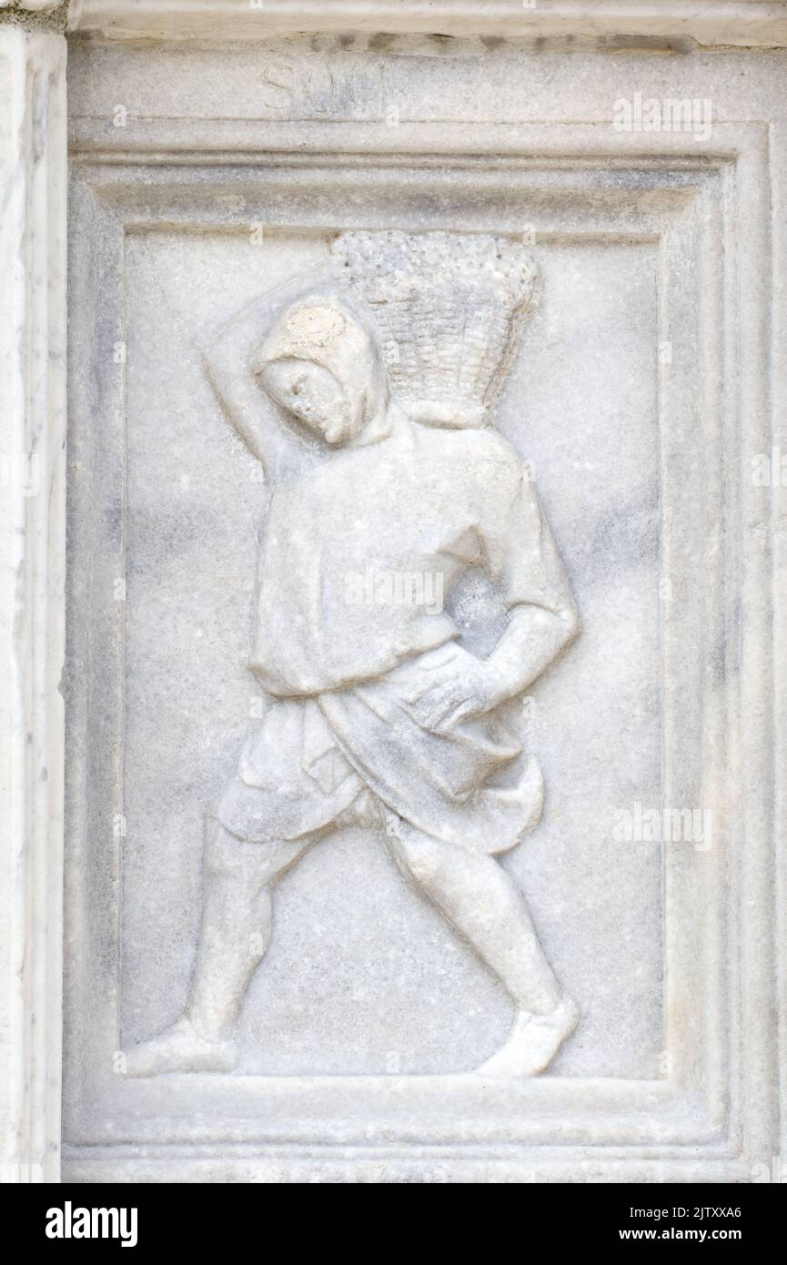 September: The crushing of grapes  - detail of Fontana Maggiore (1275), a masterpiece of medieval sculpture symbol of the city of Perugia - Italy Stock Photo