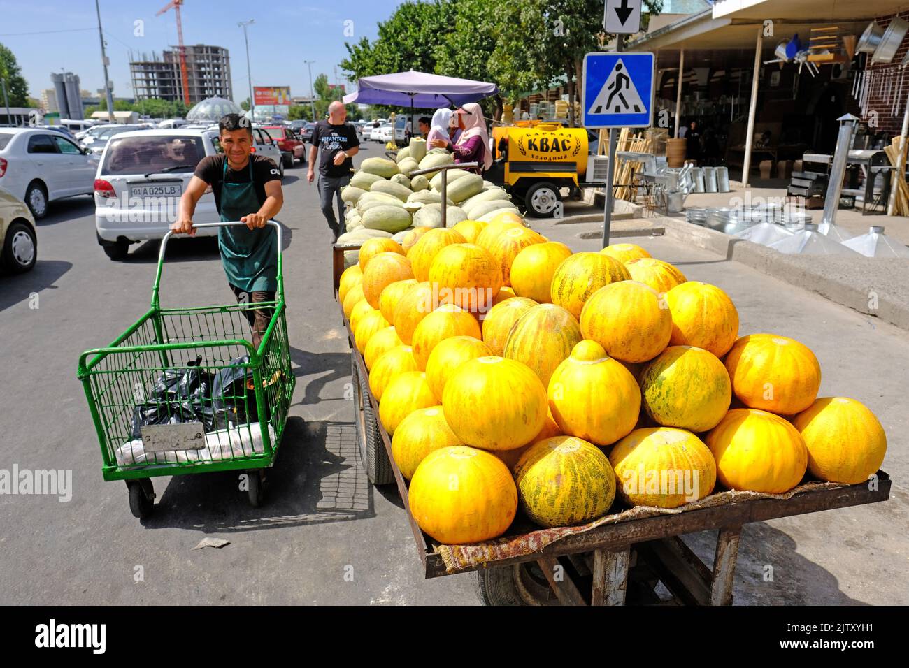 Street vendor selling fresh ripe melons just outside the Chorsu Bazaar in Tashkent Uzbekistan in August 2022 Stock Photo