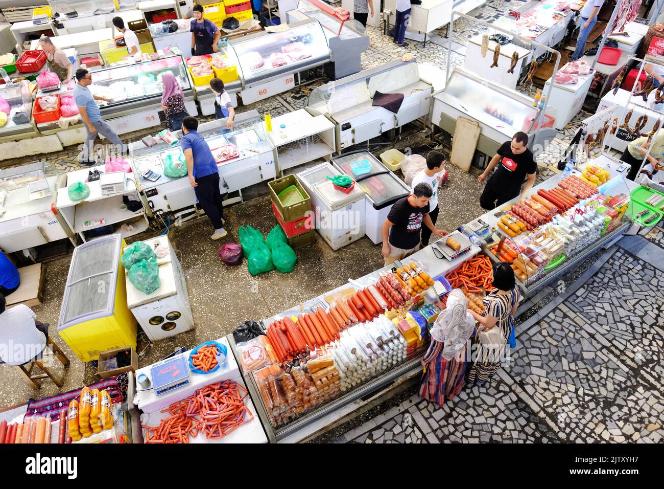 Chorsu Bazaar in Tashkent Uzbekistan customers visit a sausage stall in the meat section in August 2022 Stock Photo