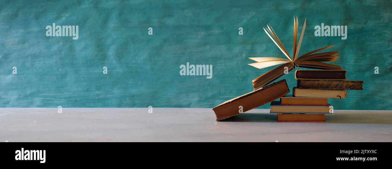 Open Book on a pile of old books, reading,education,learning concept,panoramic, good copy space Stock Photo