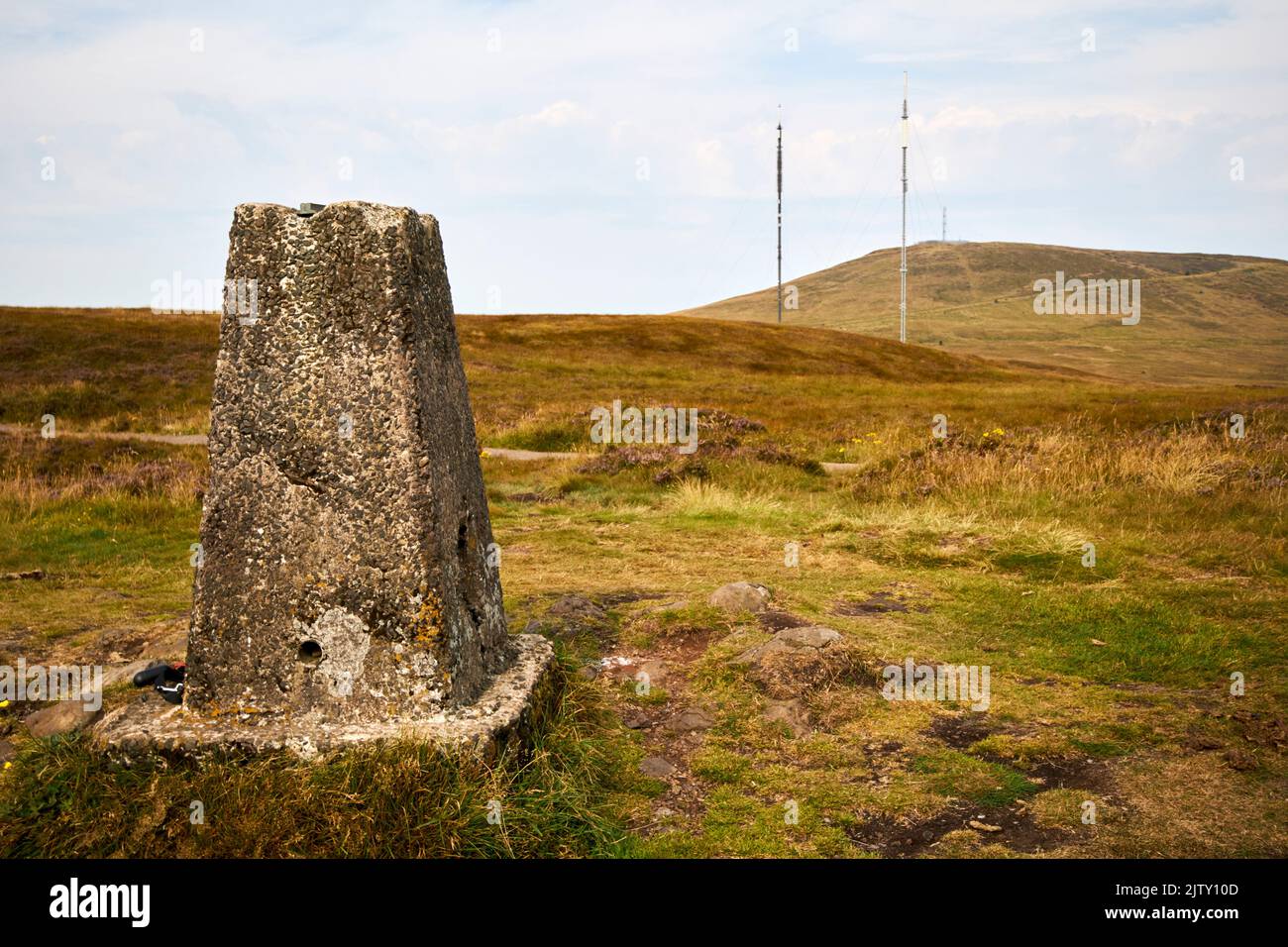 trig point on summit of black mountain with Black mountain transmitting station and the peak of divis mountain in the background in divis and black mo Stock Photo