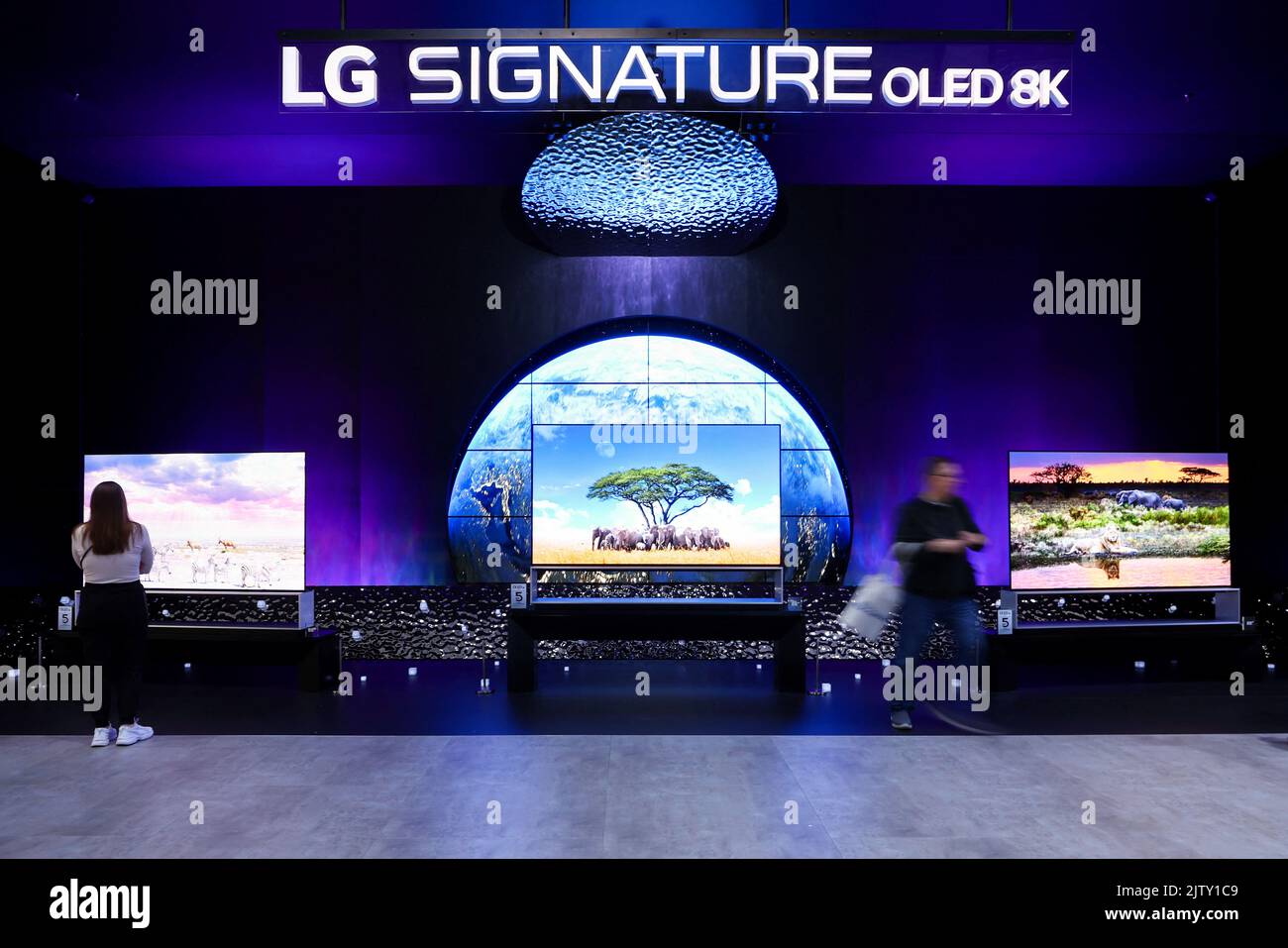 Visitors look at the OLED TV screens from LG showcased at the international consumer technology fair IFA in Berlin, Germany September 2, 2022. REUTERS/Lisi Niesner Stock Photo