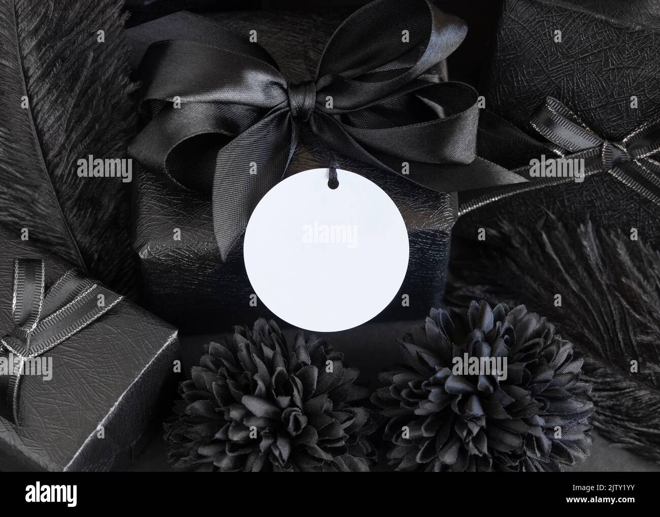 Wrapped Gift Boxes with black paper flowers and decorations and round